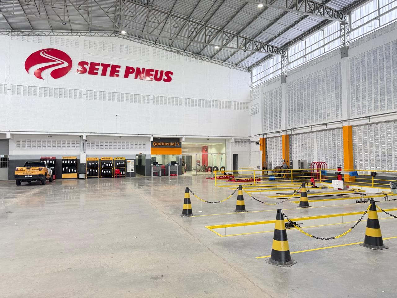 Filial da Sete Pneus, com o logotipo na parede, área de alinhamento e atendimento Continental